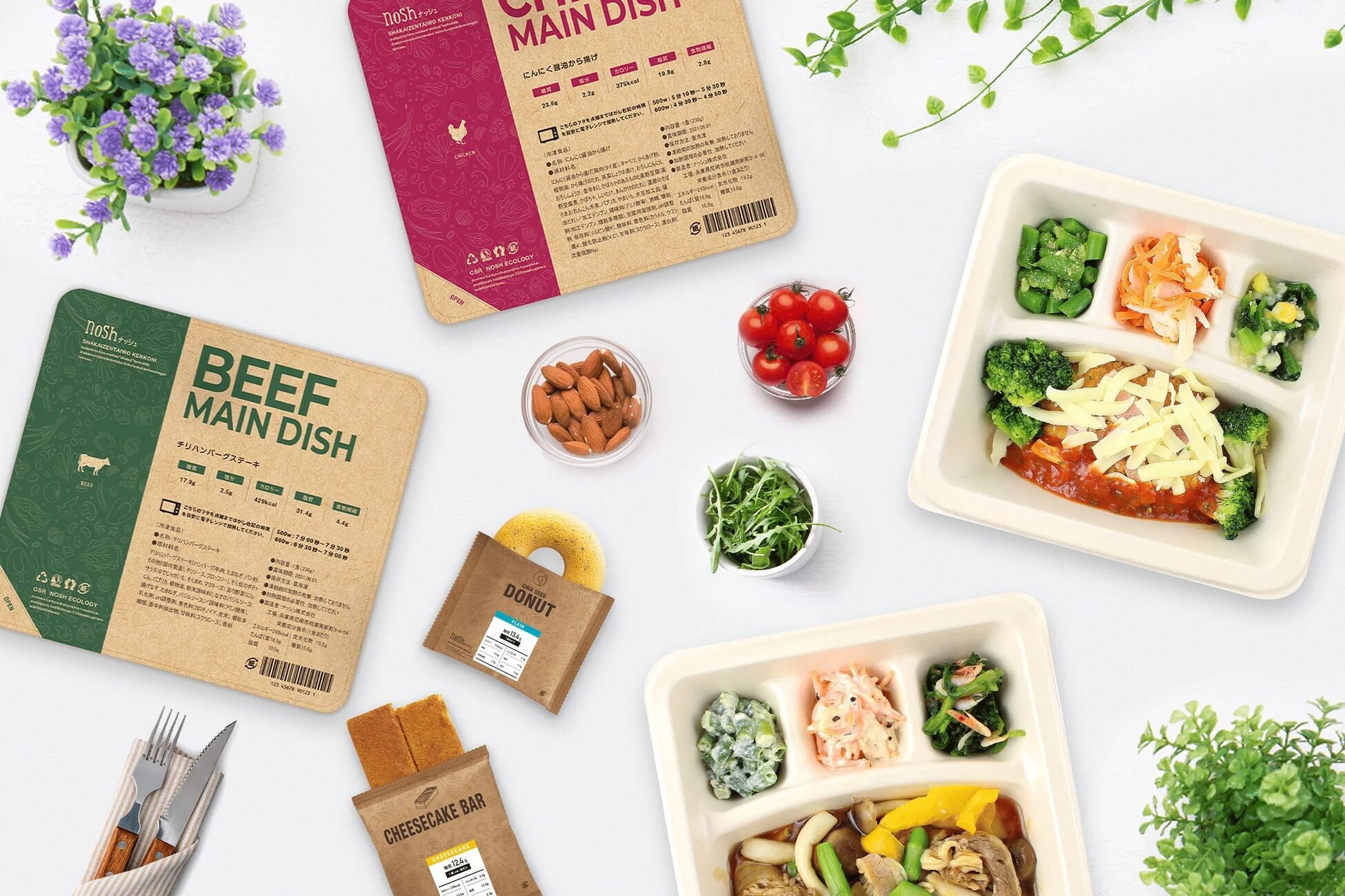 白い背景に、冷凍宅配食サービス「nosh（ナッシュ）」のメインディッシュとスイーツが広げられている様子です。チリハンバーグステーキとから揚げの弁当、ドーナツやチーズケーキバーのパッケージ、そして調理済みの弁当が並び、健康的な食生活を提案する内容が伝わります。